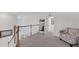 Upstairs hallway with carpet, chair, and wooden railing looking over the floor below at 1951 E Isles Rd, Port Charlotte, FL 33953