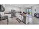Bright kitchen features stainless steel appliances, a large island with a sink and granite countertops at 1951 E Isles Rd, Port Charlotte, FL 33953
