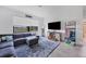 Relaxing living room with comfortable seating, television, and plenty of natural light at 1951 E Isles Rd, Port Charlotte, FL 33953