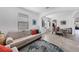 Cozy living area features a comfortable sofa, neutral decor, and a view of the dining area at 1951 E Isles Rd, Port Charlotte, FL 33953