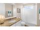 The bathroom includes a sleek granite vanity, a shower-tub combo, and lots of natural light at 19825 Bridgetown Loop, Venice, FL 34293