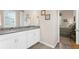 Bathroom featuring a dual sink vanity, granite countertops, and window with shutters at 19825 Bridgetown Loop, Venice, FL 34293