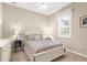 Bedroom featuring a comfortable bed, a dresser, and a bright window with shutters at 19825 Bridgetown Loop, Venice, FL 34293