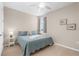 This bedroom is a cozy and peaceful retreat, featuring soft blue bedding and natural light at 19825 Bridgetown Loop, Venice, FL 34293