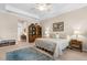 Cozy bedroom showcasing the bed with a vintage rug and a bookcase in the corner at 19825 Bridgetown Loop, Venice, FL 34293