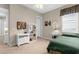 This bedroom features a twin bed, ceiling fan, and white shelving unit at 19825 Bridgetown Loop, Venice, FL 34293