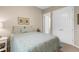 Bedroom highlighting a comfortable bed, neutral paint, and double door closet at 19825 Bridgetown Loop, Venice, FL 34293