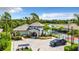 Oasis West Villages featuring a clubhouse, pool and tennis court with nice landscaping, near a tranquil lake at 19825 Bridgetown Loop, Venice, FL 34293