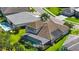 Aerial view of home showcasing a screened-in pool and tile roof, with manicured landscaping in a beautiful community at 19825 Bridgetown Loop, Venice, FL 34293