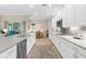 Well lit kitchen featuring stainless steel appliances, modern fixtures, and an island at 19825 Bridgetown Loop, Venice, FL 34293
