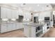 Spacious kitchen with white cabinets, stainless steel appliances, and an island at 19825 Bridgetown Loop, Venice, FL 34293