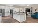 Bright, open kitchen with a large island, stainless appliances, and hardwood floors at 19825 Bridgetown Loop, Venice, FL 34293