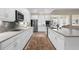 Spacious kitchen featuring white cabinets, stainless steel appliances and tile backsplash at 19825 Bridgetown Loop, Venice, FL 34293