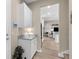 The mudroom features a stylish gray granite countertop, white cabinets, and a view into the home's common areas at 19825 Bridgetown Loop, Venice, FL 34293