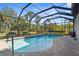 Beautiful pool featuring a screen enclosure, and stone surround with room to enjoy the outdoors at 19825 Bridgetown Loop, Venice, FL 34293