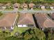 Aerial view of homes showcasing tile roofs and well-maintained lawns at 20479 Pezzana Dr, Venice, FL 34292