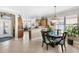 Dining area featuring a chandelier, wooden table with seating, and views into the kitchen and foyer at 20479 Pezzana Dr, Venice, FL 34292