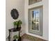 Front entrance featuring glass door, half moon table, planters and tile floor at 20479 Pezzana Dr, Venice, FL 34292