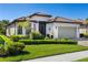 Exterior view of home with manicured lawn and landscaping at 20479 Pezzana Dr, Venice, FL 34292