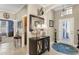 Grand foyer with a chandelier, large mirror, and decorative accents, creating an inviting entrance at 20479 Pezzana Dr, Venice, FL 34292