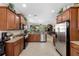 Spacious kitchen featuring wooden cabinets, granite countertops, and stainless steel appliances at 20479 Pezzana Dr, Venice, FL 34292