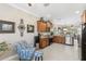Open concept kitchen with wooden cabinets, stainless steel appliances, and a cozy seating area at 20479 Pezzana Dr, Venice, FL 34292