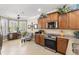 Bright kitchen with custom cabinets, granite counters, a breakfast nook, and stainless steel appliances at 20479 Pezzana Dr, Venice, FL 34292