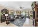 Comfortable living room with an L-shaped black leather couch, area rug, and plenty of natural light at 20479 Pezzana Dr, Venice, FL 34292