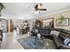 Spacious open-concept living room with modern decor and tile flooring throughout the house at 20479 Pezzana Dr, Venice, FL 34292
