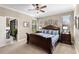 Bright main bedroom with wood furniture, a ceiling fan, and carpet at 20479 Pezzana Dr, Venice, FL 34292