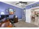 Office space featuring blue walls, carpet floors, crown molding, ceiling fan and a view to other rooms at 20479 Pezzana Dr, Venice, FL 34292