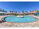 Large community pool and deck with palm trees and lounge chairs at 20479 Pezzana Dr, Venice, FL 34292