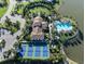 Breathtaking aerial view highlighting the community's pool, tennis courts, lush landscaping, and waterfront location at 208 Corelli Dr, Nokomis, FL 34275