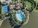Stunning aerial perspective of the community's pool, waterfront, and lush landscaping, offering a serene living experience at 208 Corelli Dr, Nokomis, FL 34275