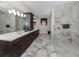 Elegant bathroom with marble walls, double vanity, and a spacious glass-enclosed shower at 208 Corelli Dr, Nokomis, FL 34275