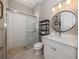 Bright bathroom features a glass enclosed shower with white subway tile and pebble floor at 208 Corelli Dr, Nokomis, FL 34275