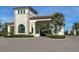 Impressive community entrance featuring an arched stone gatehouse and lush landscaping at 208 Corelli Dr, Nokomis, FL 34275