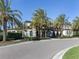 Stunning exterior elevation view featuring tropical landscaping, elegant architecture, and a well-manicured lawn at 208 Corelli Dr, Nokomis, FL 34275