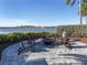Charming outdoor fire pit with comfortable seating and scenic lake views, perfect for entertaining at 208 Corelli Dr, Nokomis, FL 34275
