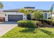 Beautiful single-story home featuring a two-car garage and lush landscaping at 208 Corelli Dr, Nokomis, FL 34275