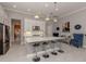 Kitchen island with seating and pendant lights, complemented by stainless steel appliances at 208 Corelli Dr, Nokomis, FL 34275
