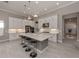 Spacious kitchen with a large center island, white cabinets, stainless steel appliances, and modern pendant lighting at 208 Corelli Dr, Nokomis, FL 34275
