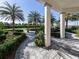 Beautifully landscaped grounds with lush greenery, a charming fountain, and paved walkways at 208 Corelli Dr, Nokomis, FL 34275