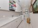 Functional laundry room features ample storage, a utility sink, and a modern washer and dryer at 208 Corelli Dr, Nokomis, FL 34275