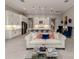 Open concept living room showcasing a modern kitchen, white sofa, and stylish decor, creating a comfortable living space at 208 Corelli Dr, Nokomis, FL 34275