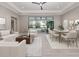 Open-concept living and dining area with sliding doors to outdoor pool at 208 Corelli Dr, Nokomis, FL 34275