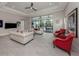 Bright living room with stylish seating, tile floors, large windows, and access to the outdoor pool area at 208 Corelli Dr, Nokomis, FL 34275