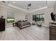 Spacious main bedroom with tray ceiling, neutral colors, and a view from the window at 208 Corelli Dr, Nokomis, FL 34275