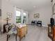 Stylish home office with natural light, hardwood floors, and elegant furnishings at 208 Corelli Dr, Nokomis, FL 34275