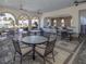 Elegant outdoor dining area with a bar and comfortable seating, ideal for al fresco meals and gatherings at 208 Corelli Dr, Nokomis, FL 34275
